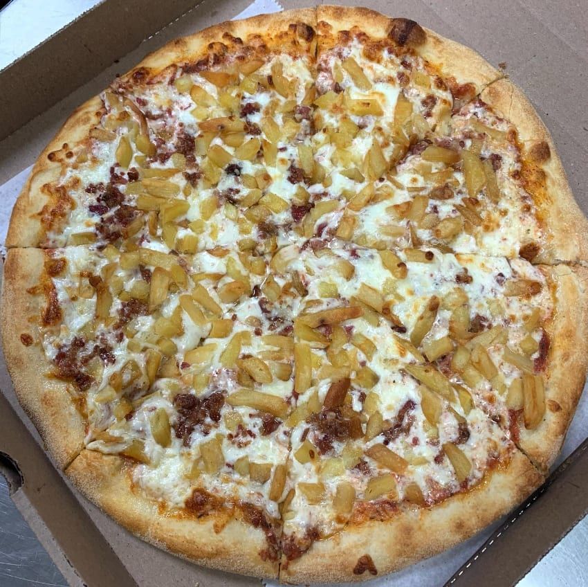 A white pizza with onions in the box